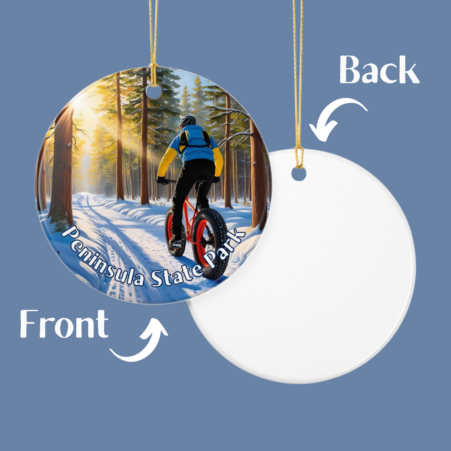 Two sides of a round ornament showing a person on a bike in a snowy forest and a plain white side.