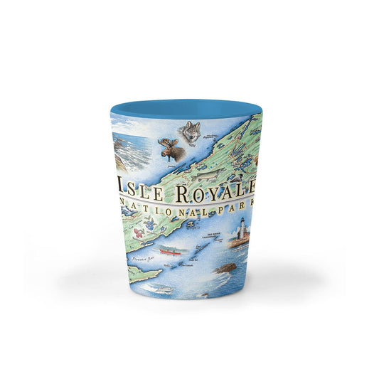 A cylindrical shot glass featuring a detailed illustrated map of Isle Royale National Park, with a solid blue rim and interior, set against a plain white background.