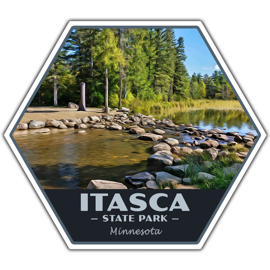A hexagonal travel-style sticker featuring a scenic lakeside forest with rocks in the foreground and the text 'ITASCA STATE PARK Minnesota' on a dark lower section, shown on a white background.