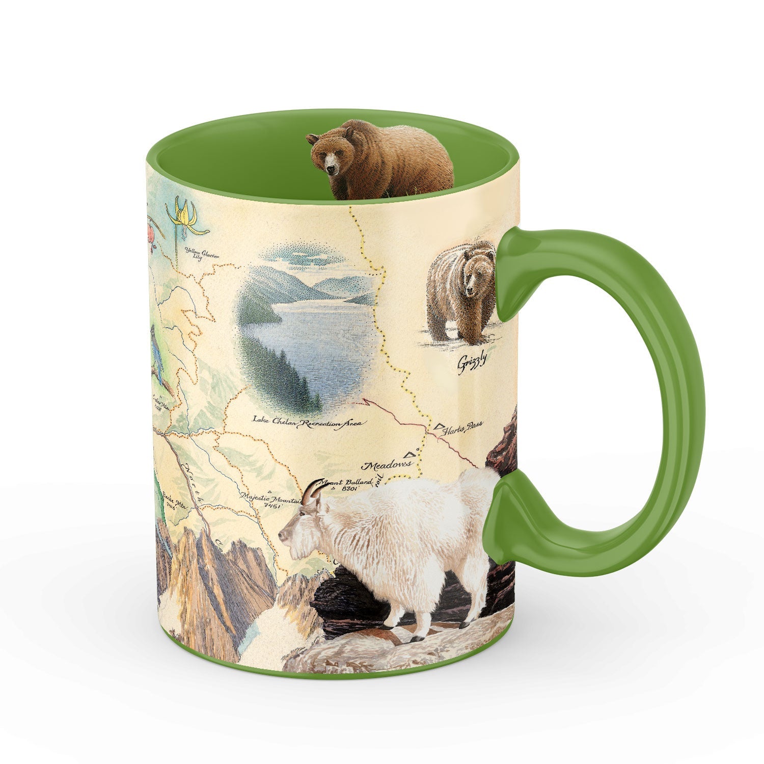 A ceramic mug with a green handle and interior, featuring a vintage-style map print decorated with mountain scenery, a white goat, a grizzly bear, and a brown bear on top.