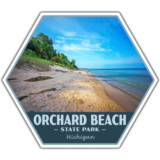 A hexagonal sticker featuring a beach scene from Orchard Beach State Park, Michigan, with a sandy shore, blue water, green trees, and a dark blue banner at the bottom reading “ORCHARD BEACH • STATE PARK • Michigan.”.