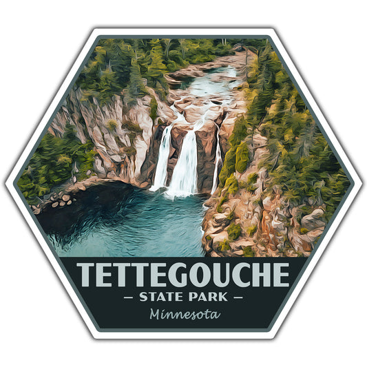 A hexagonal travel-style sticker or patch featuring an illustrated waterfall landscape in Tettegouche State Park, Minnesota, with the text “TETTEGOUCHE • STATE PARK • Minnesota” on a dark band at the bottom.