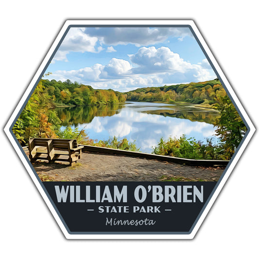 A hexagonal scenic sticker featuring a lake landscape with autumn trees, two wooden benches in the foreground, and the text 'WILLIAM O’BRIEN — STATE PARK — Minnesota' along the bottom.