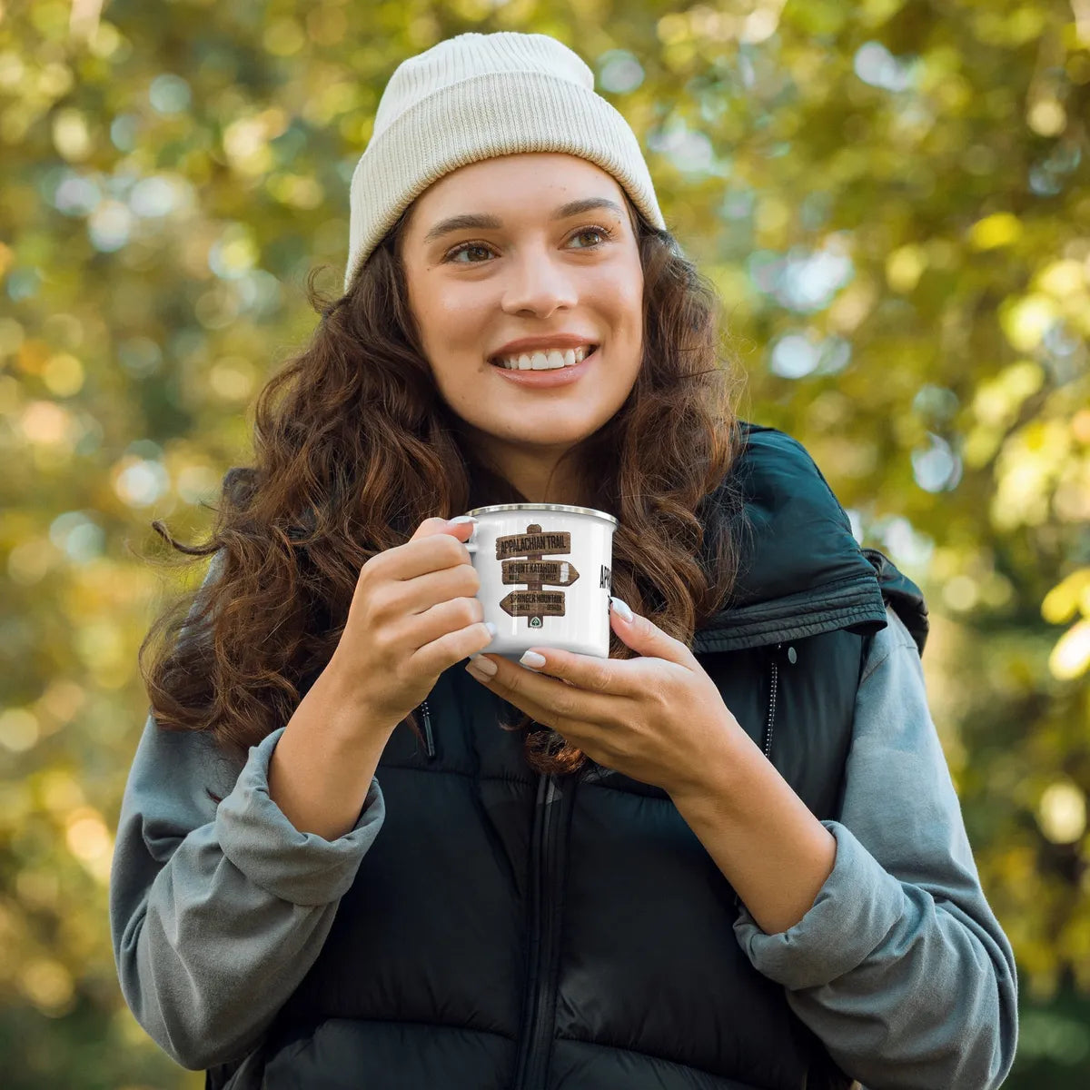 Female hiker, holding an Appalachian Trail camp mug while in the woods