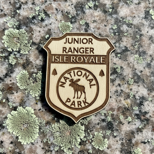 Junior Ranger Isle Royale National Park badge on a lichen-covered rock