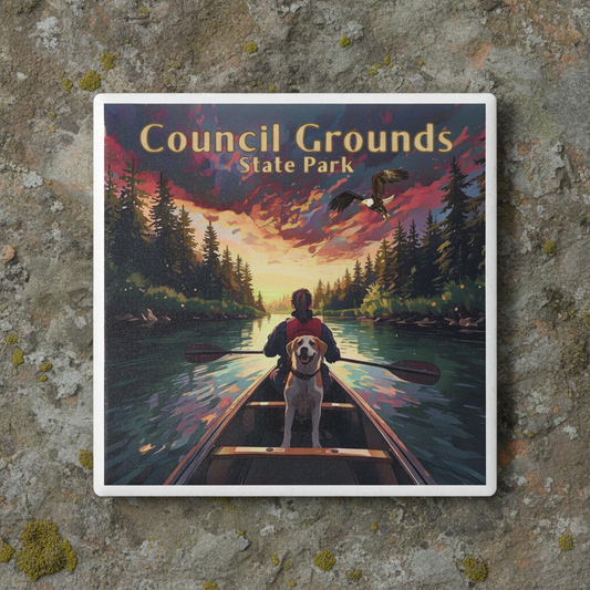 Coaster on stone surface depicting a person in a canoe with a dog paddling on a river at sunset