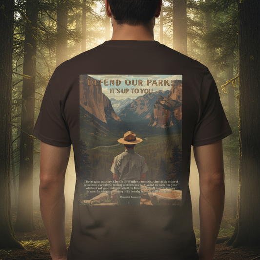 Person wearing a dark brown shirt in the woods with a graphic of a Park Ranger overlooking Yosemite national Park with the text “Defend our parks. It’s up to you!” And an inspiring quote.