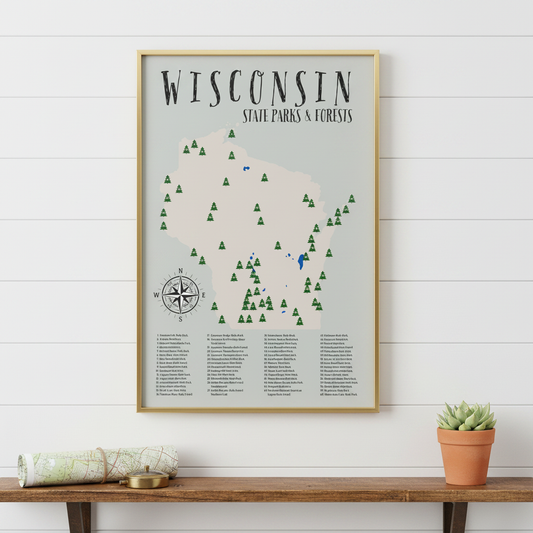Framed poster map of Wisconsin State Parks and Forests on a wall above a wooden shelf with a plant.