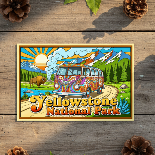 A colorful Yellowstone National Park sticker featuring a retro van, mountains, and the park name, styled on a rustic wooden surface with pinecones and green leaves.