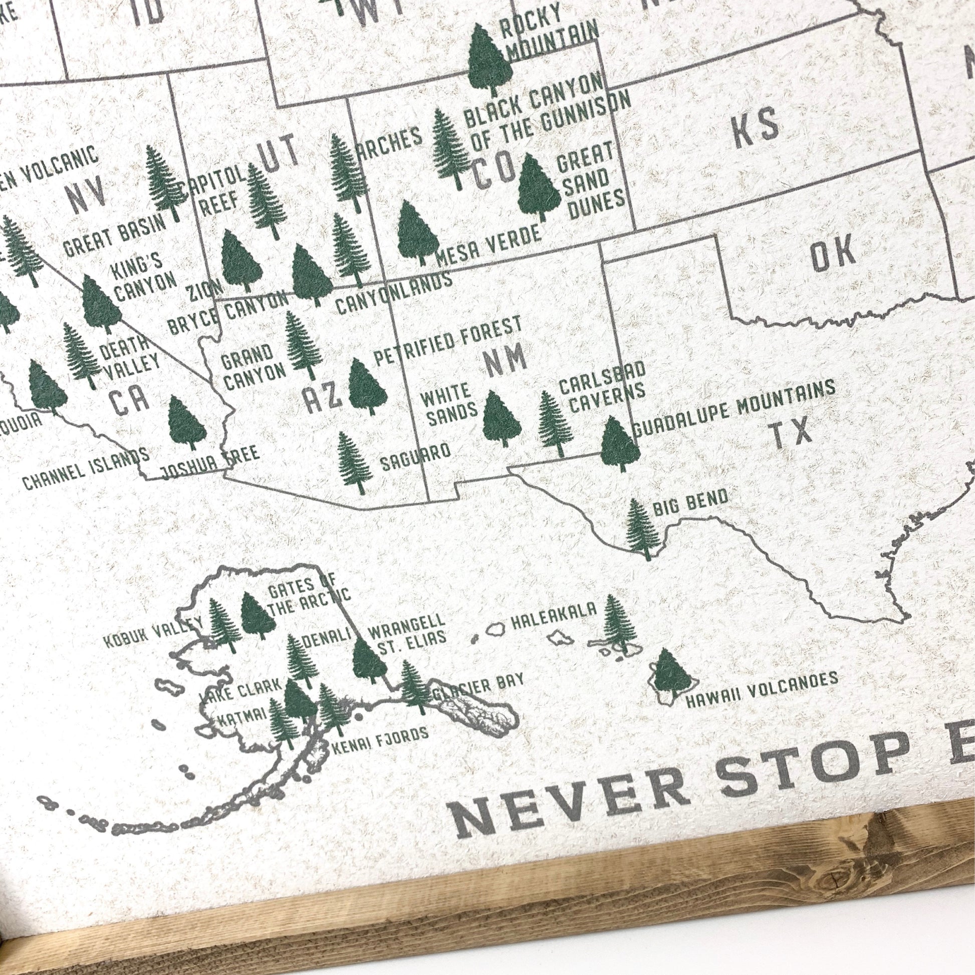 Map of the United States with national parks marked, featuring trees and text on a white background.