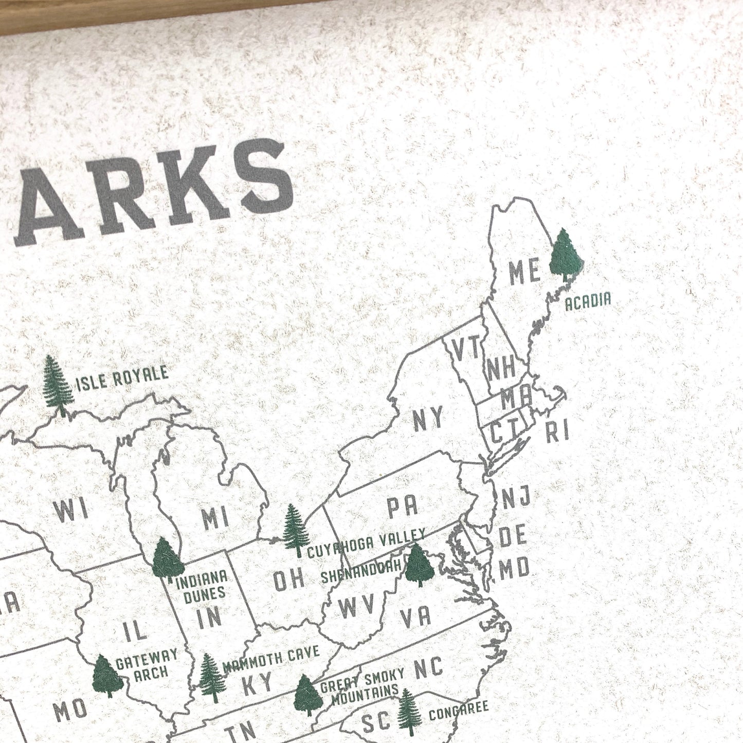 Map of the United States with labeled states and national parks on a textured surface