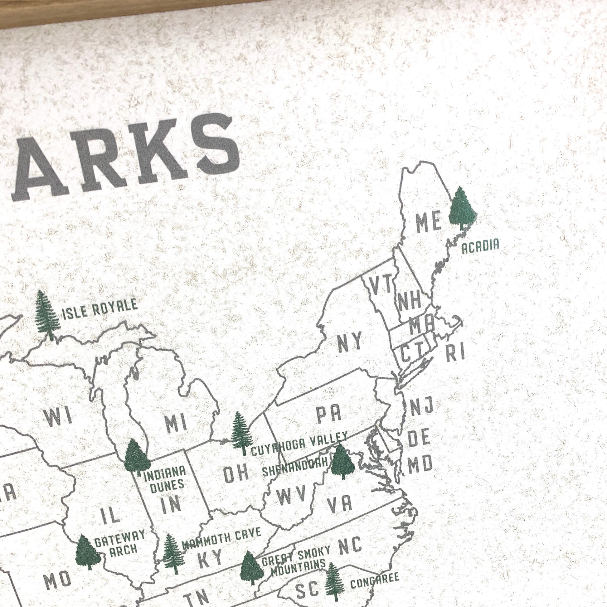 Map of the United States with labeled states and national parks on a textured surface