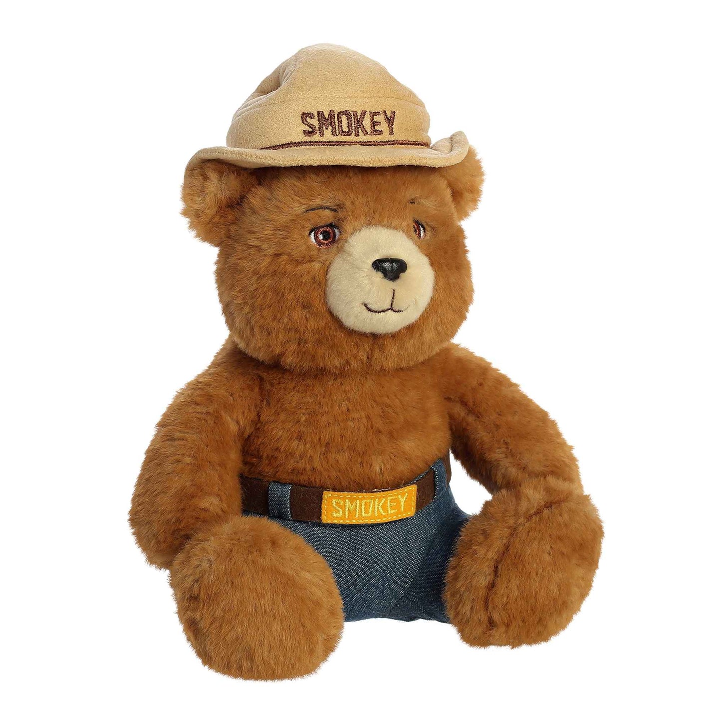 Plush teddy bear wearing a Smokey bear hat and overalls on a white background