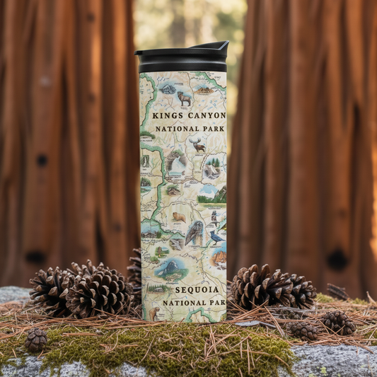 A tall insulated tumbler with a Kings Canyon National Park map design stands on moss and pine needles outdoors, surrounded by pinecones, with a blurred wooden fence background.
